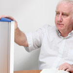 man with light box for SAD