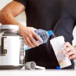 Cropped image of a bodybuilder making himself a protein shake