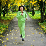 woman running autumn path