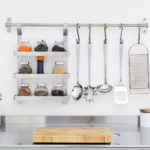 Kitchen utensils and spices in bowls in stainless steel kitchen