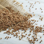 Buckwheat on the wooden table, close up