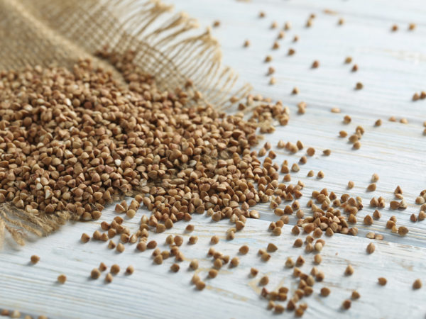 Buckwheat on the wooden table, close up