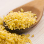 bulgur wheat in wooden spoon