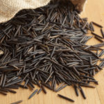 Raw black wild rice from a jute bag