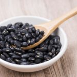 Black Beans in wooden spoon with seramic bowl