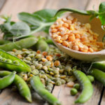 young green peas in pods and dry grains