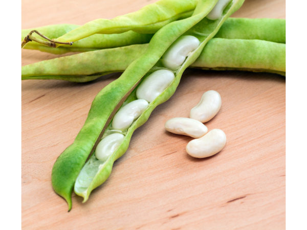 green pod white beans close-up on a wooden table. vegetables, cereals. macro..
