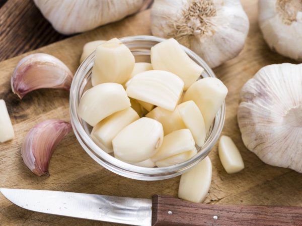 Rustic style Garlic (peeled) on vintage wooden background