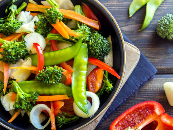 Healthy stir fried vegetables in the pan and ingredients close up