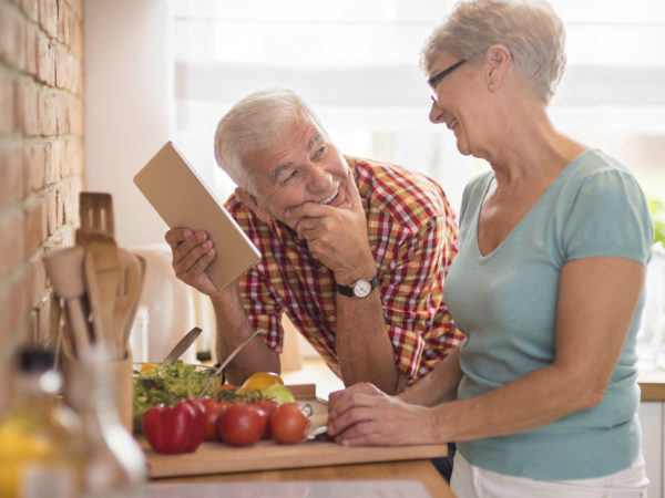 Modern senior couple spending time in the kitchen