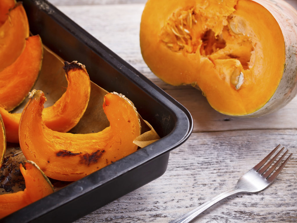 Roast pumpkin sitting on baking parchment