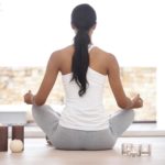 Rearview image of a woman meditating at home