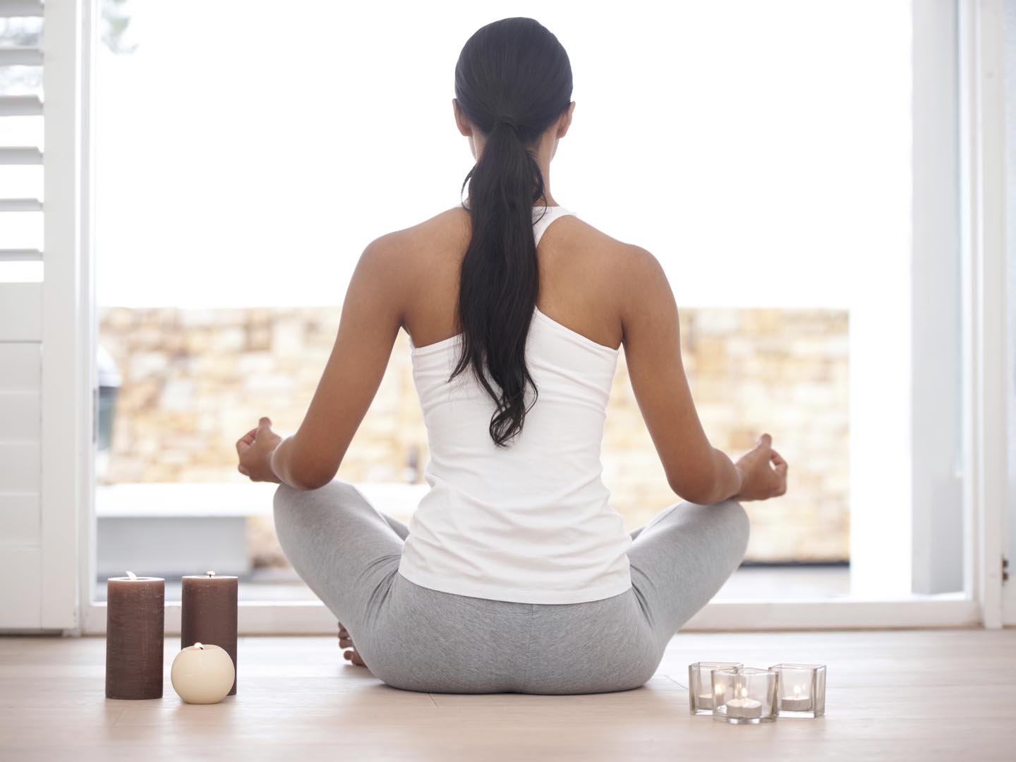 Rearview image of a woman meditating at home