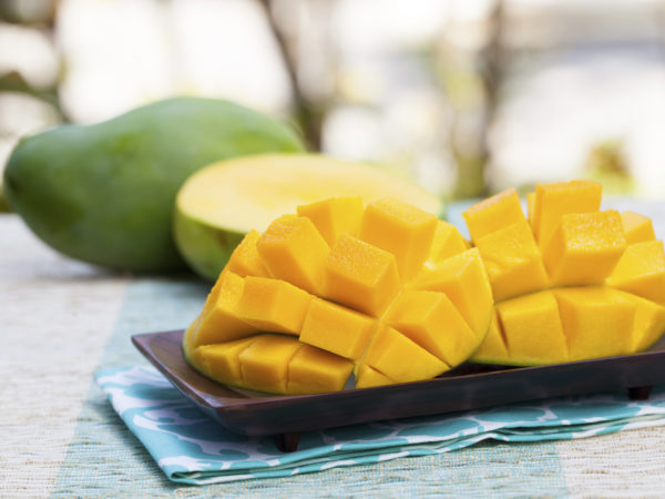 Fresh mango organic product on a tropical outdoor background Copy space