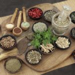 Herb and spice health food selection for men in wooden bowls and spoons. Used in natural alternative herbal medicine.