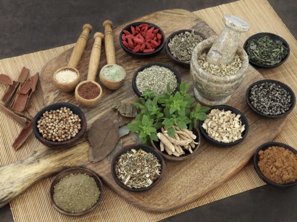 Herb and spice health food selection for men in wooden bowls and spoons. Used in natural alternative herbal medicine.