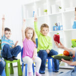 &quot;Portrait of an cute children talking about vegetable in a preschool, selective focus to children with arms raised guessing, teacher learning children about vegetable. Holding paprika.&quot;