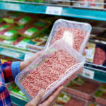 Buyer chooses minced meat in a store