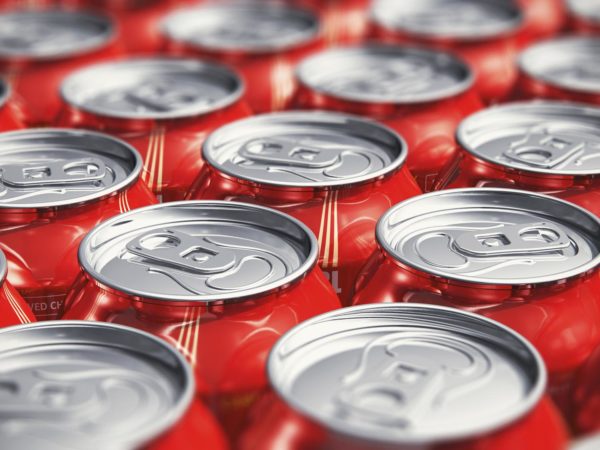 Macro view of color drink tin cans with cola soda beverage with selective focus effect