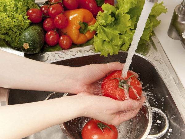 "Vegetables washing, splashing water, fresh salad preparation"