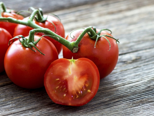 Fresh tomatoes on wood background