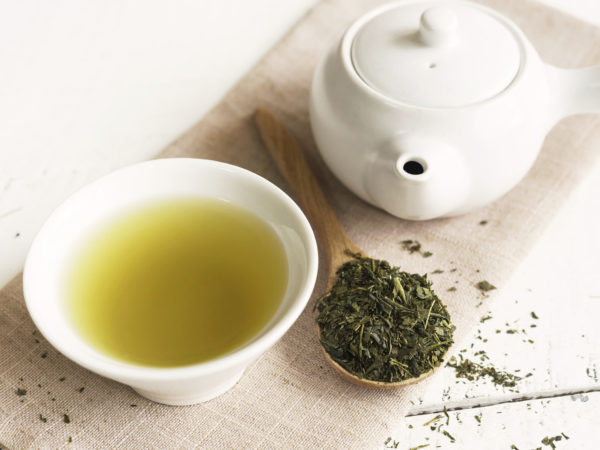 Japanese green tea on white wooden table