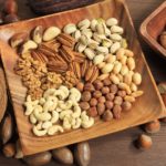 Assorted nuts in wooden bowl.