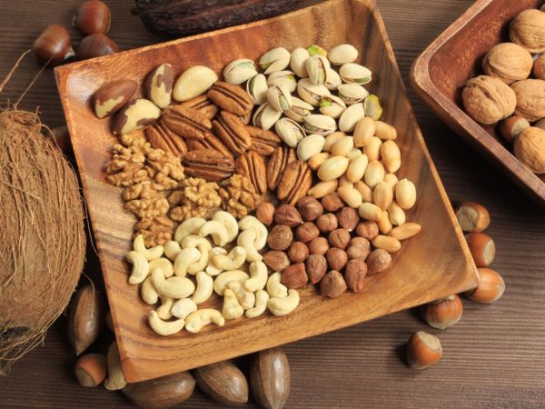 Assorted nuts in wooden bowl.