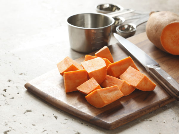 preparation of sweet potatoes on cutting board.