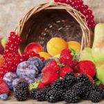 Freshly harvested seasonal Fruits, with a Basket