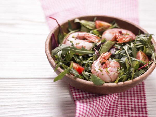 Green salad with shrimps on wooden table.healthy food