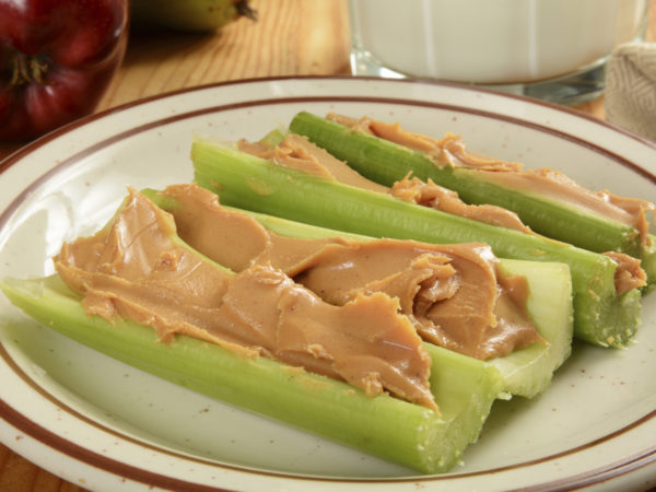 Crispy celery sticks with organic peanut butter and milk