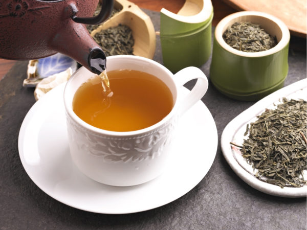 Green Tea Pouring into a Cup