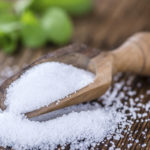 Old wooden table with Stevia Granules (selective focus; close-up shot)