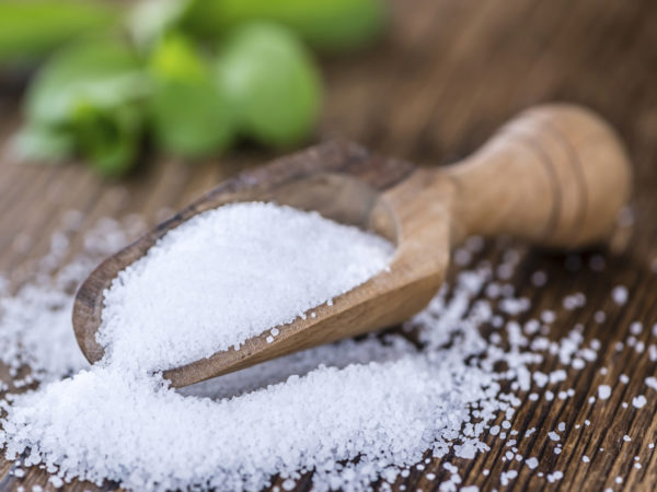 Old wooden table with Stevia Granules (selective focus; close-up shot)