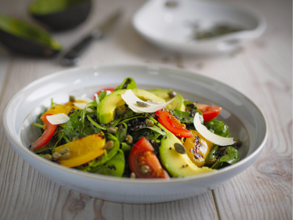 Home made healthy quinoa salad with avocado,roasted pepper and capes,parmesan cheese