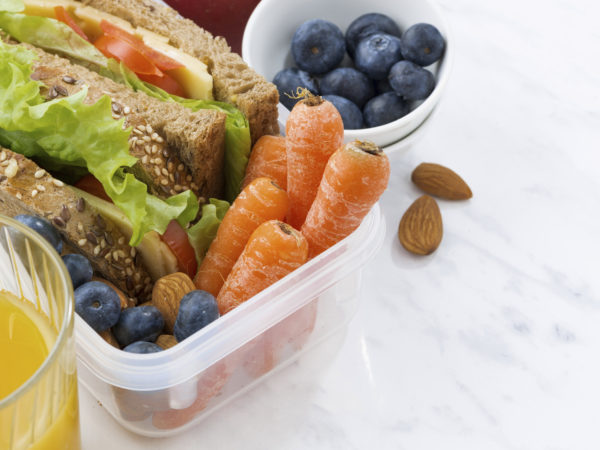 lunch box with sandwich of wholemeal bread on white background, closeup