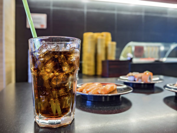 Cola in glass isolated on food background with soft focus