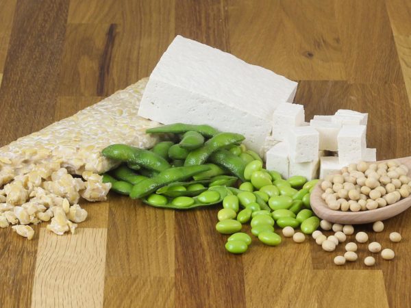 Soy beans, tofu, tempeh, edamame on wood