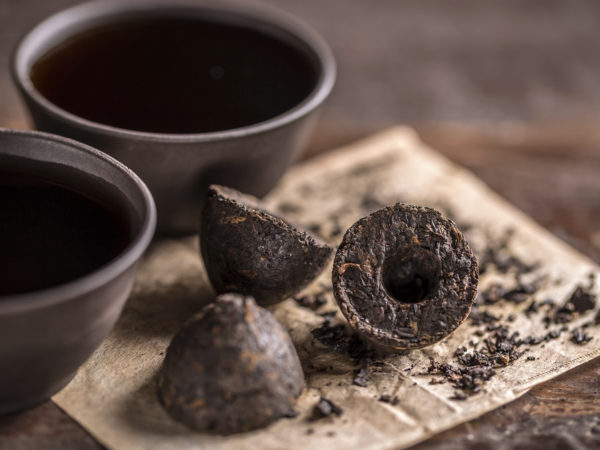 Still life with pressed pu-erh tea and crockery tea set