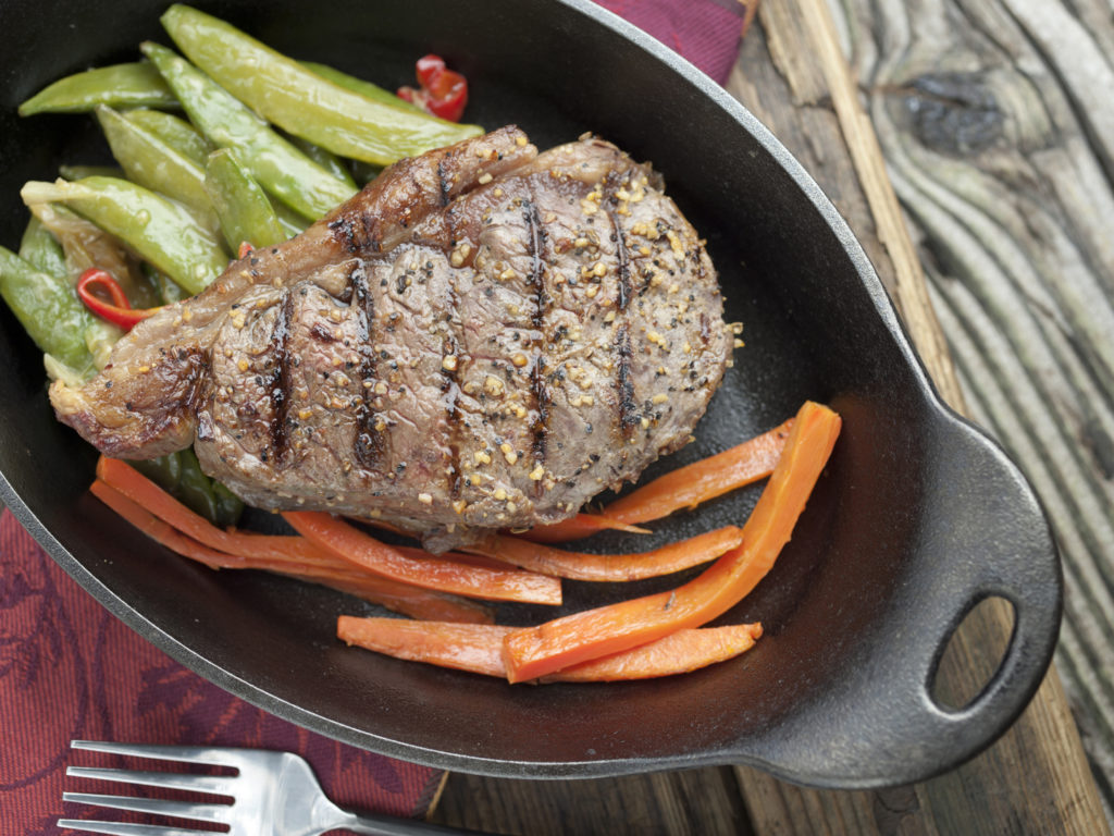 Sizzling Grilled Steak made of Buffalo meat looking from top.