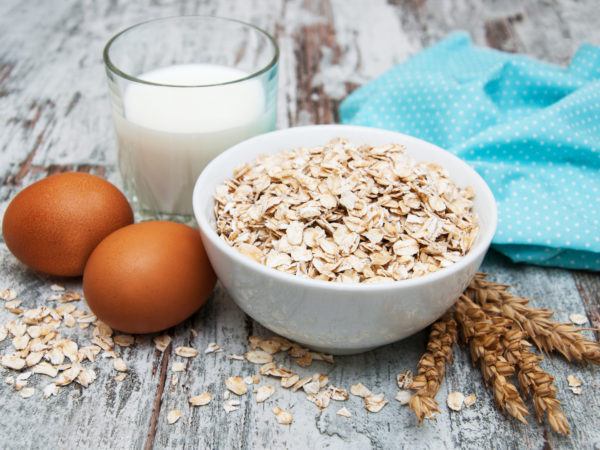 Bowl of oats on a old wooden background