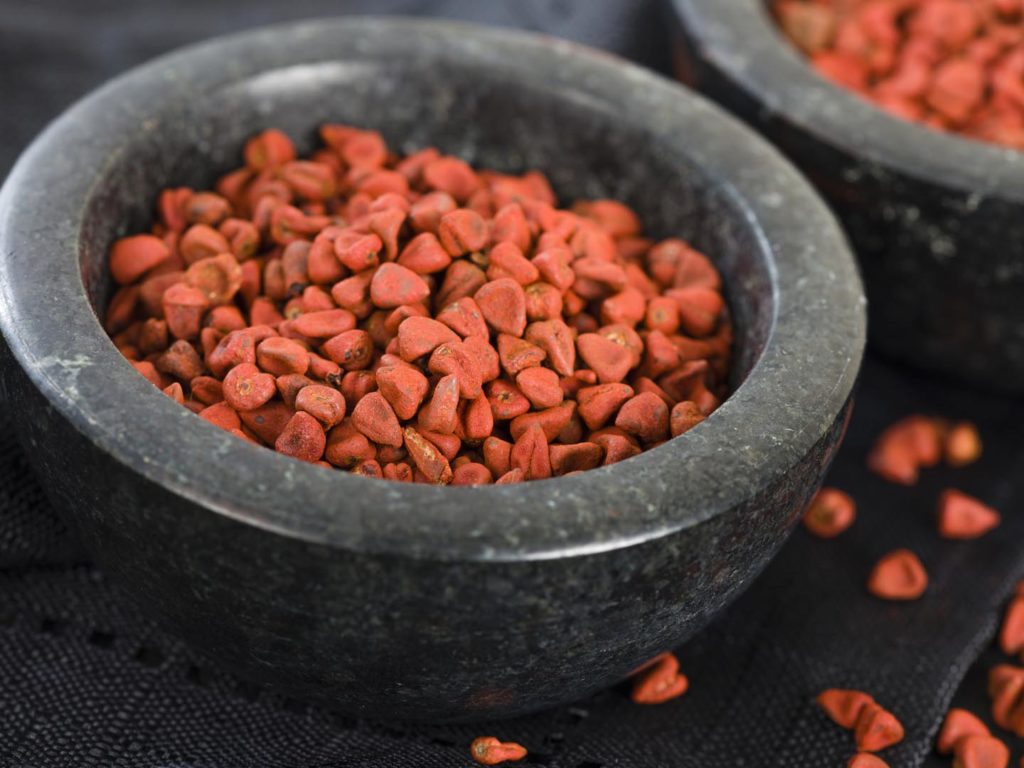 Annatto Seeds - Annatto (achiote) seeds in a black bowl.