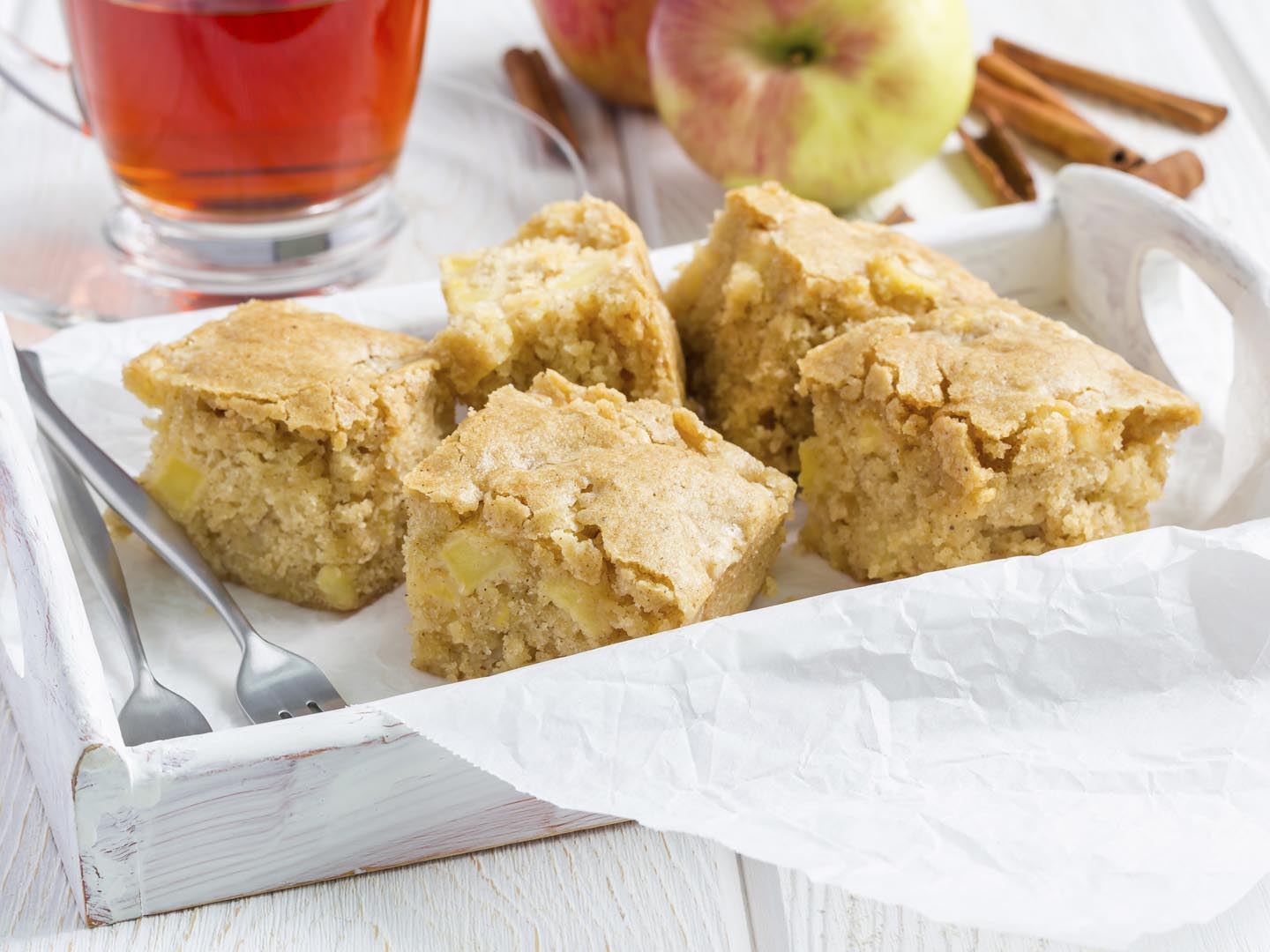 Homemade blondie (blonde) brownies apple cake, square slices in wooden tray, horizontal