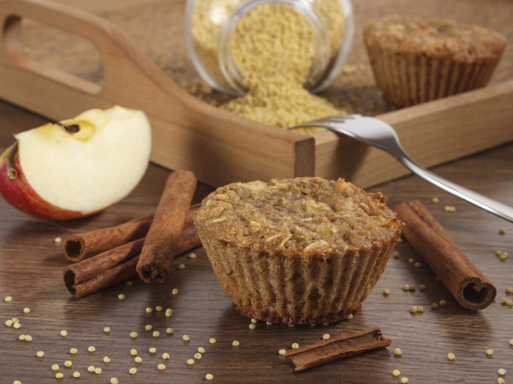 Fresh muffins with millet groats, oatmeal flakes, cinnamon and apple baked with wholemeal flour, concept of delicious, healthy dessert