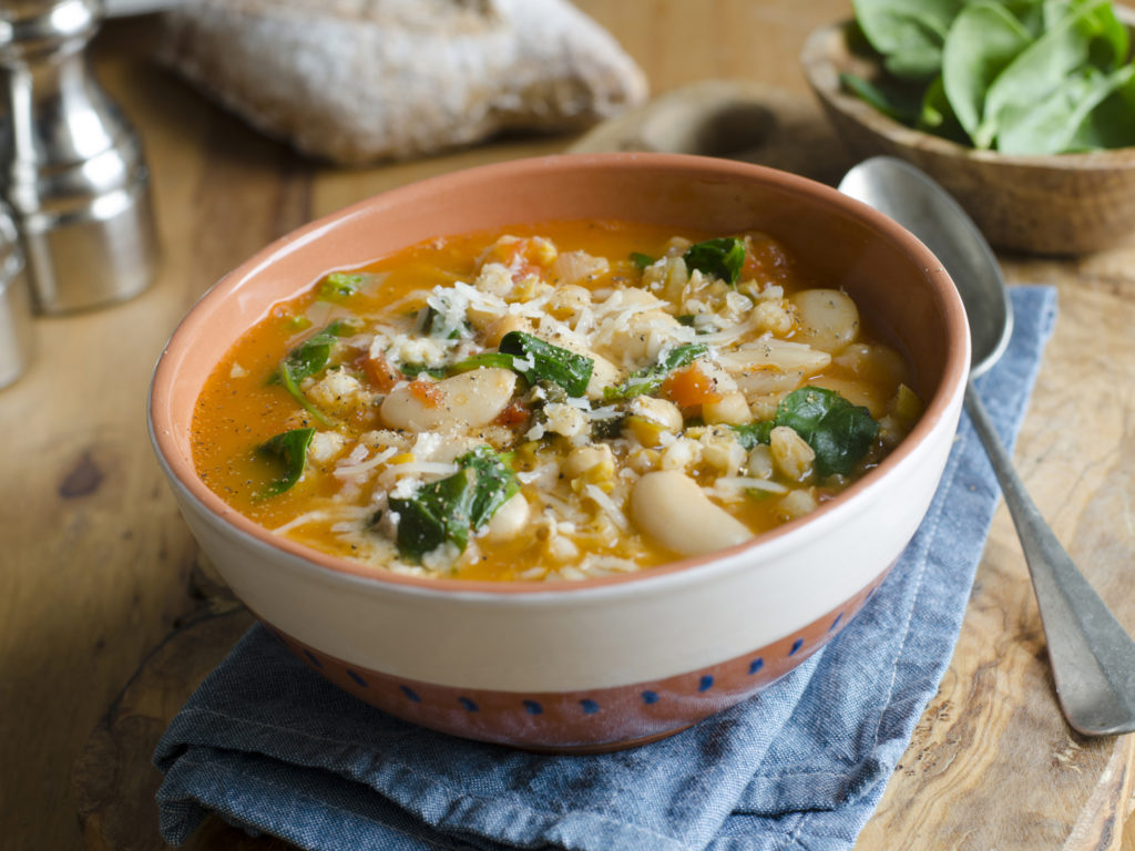Pearl barley, butter bean and chickpea soup topped with grated Parmesan