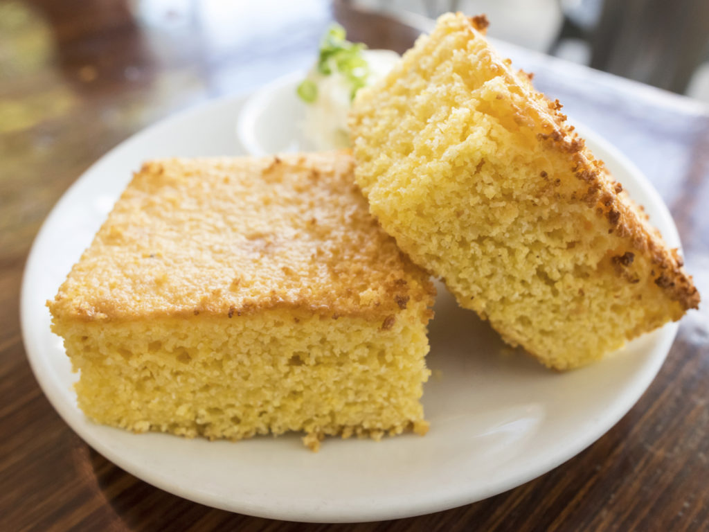 Two pieces of fresh organic corn bread