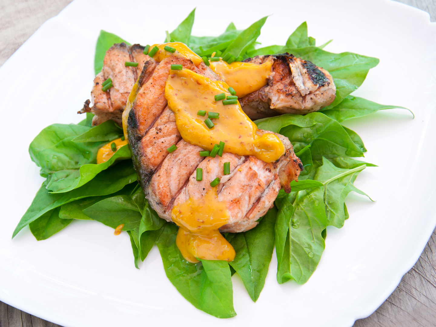 grilled salmon on spinach pillow with orange-mustard sauce