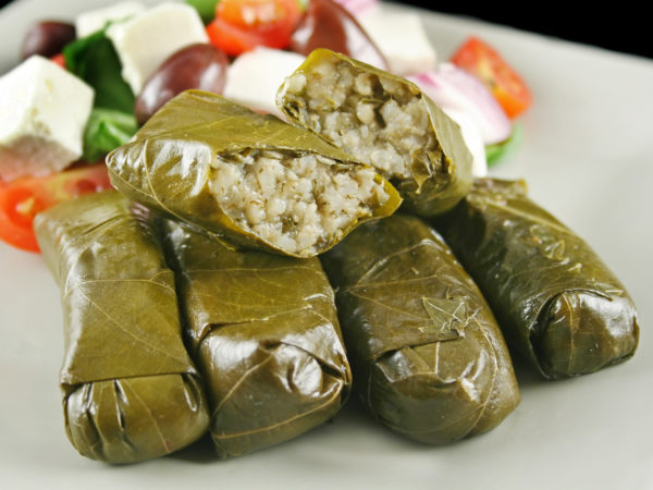 Greek dolmades wrapped with vine leaves and rice with salad.