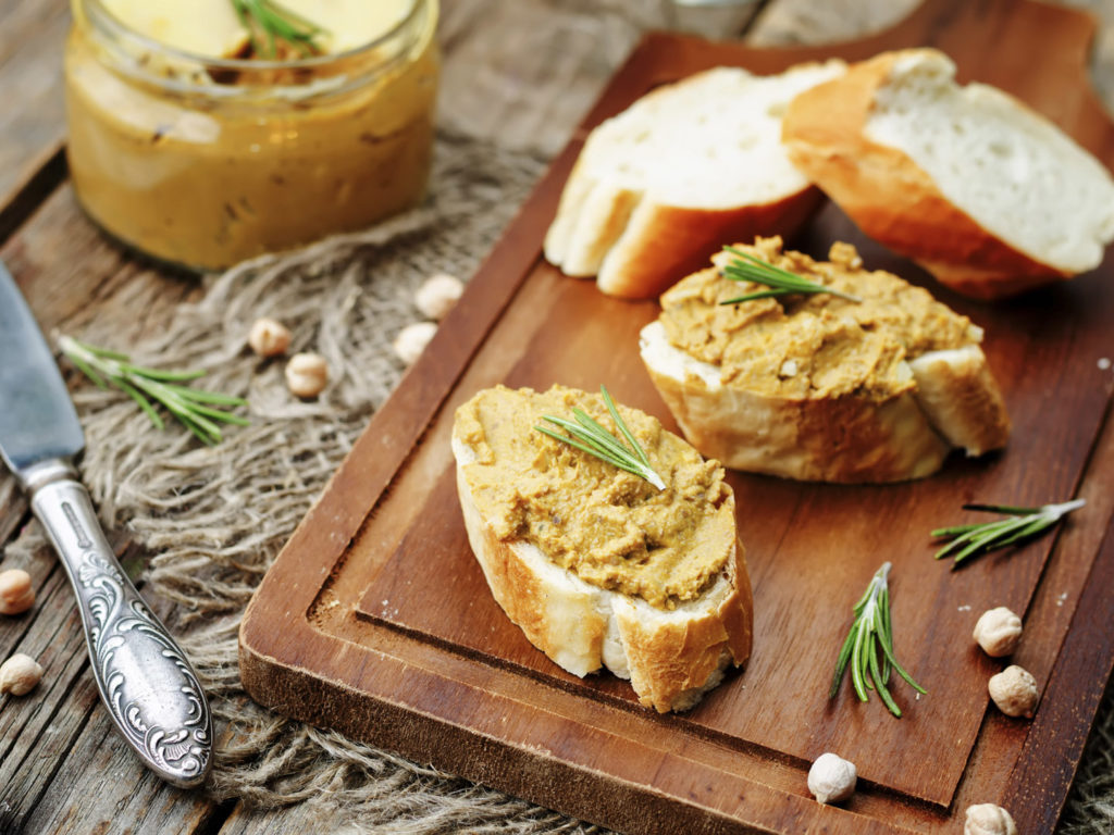 chickpeas pumpkin turkey liver pate on a dark wood background. toning. selective Focus